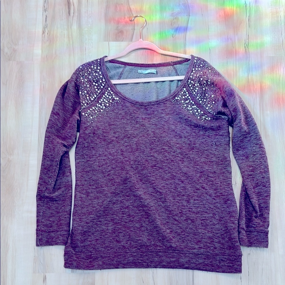 Woman’s purple sweater with gem encrusted shoulders
